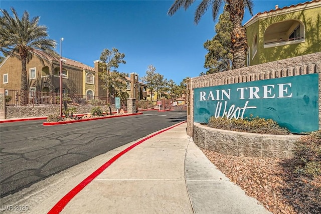 exterior space featuring a gated entry, curbs, and sidewalks