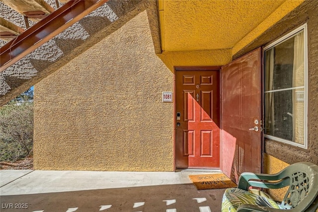 property entrance with stucco siding