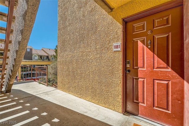 view of exterior entry featuring stucco siding