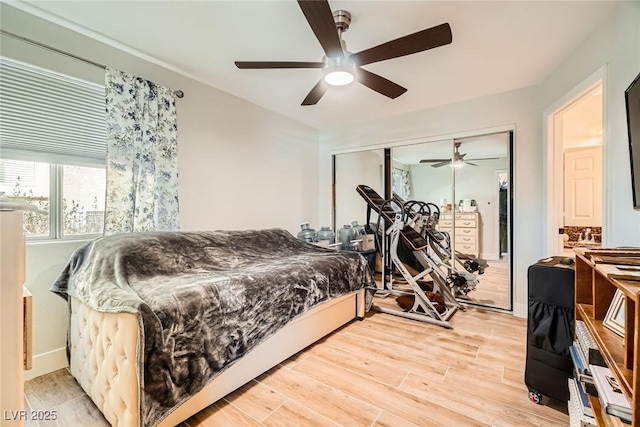 bedroom featuring light wood-style flooring, a closet, and ceiling fan