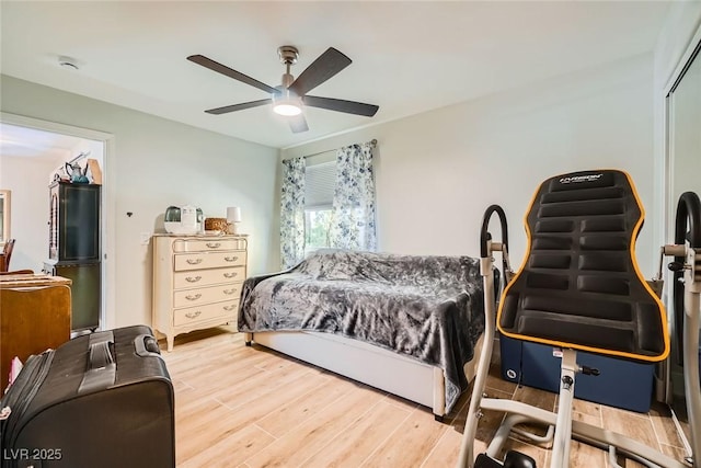 bedroom with wood finished floors, a closet, and ceiling fan