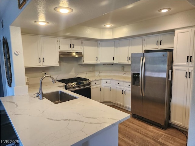 7950 W Flamingo Rd Unit 1081, Las Vegas, NV 89147 - kitchen featuring appliances with stainless steel finishes, a peninsula, under cabinet range hood, light stone counters, and white cabinets