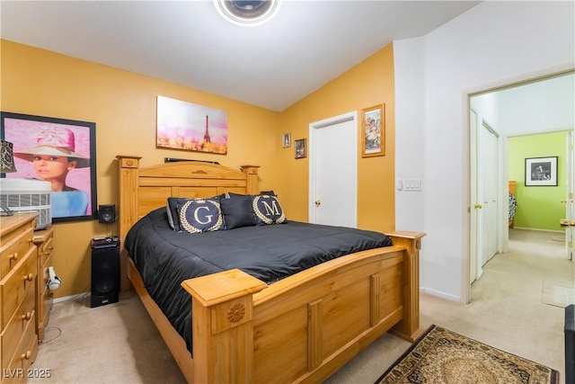 carpeted bedroom featuring vaulted ceiling