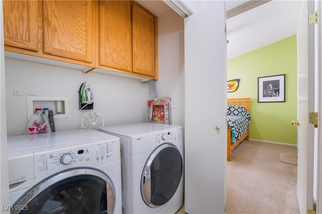 laundry area with cabinets, light carpet, and independent washer and dryer