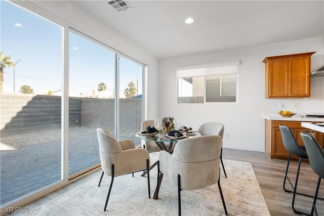 dining space with light wood-type flooring