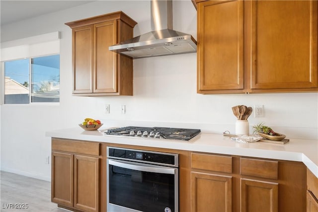 kitchen featuring appliances with stainless steel finishes and wall chimney exhaust hood