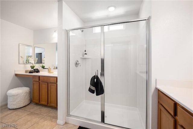 bathroom with tile patterned floors, vanity, and a shower with door