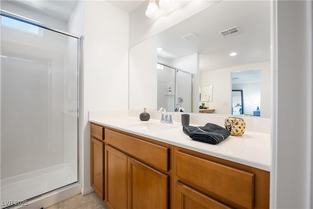 bathroom featuring vanity and a shower with shower door