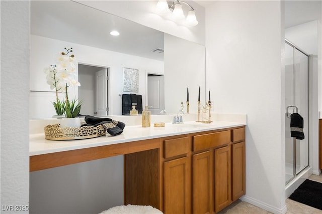 bathroom with vanity and a shower with shower door