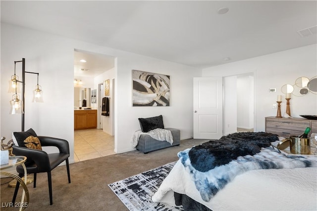 bedroom with light carpet and ensuite bath