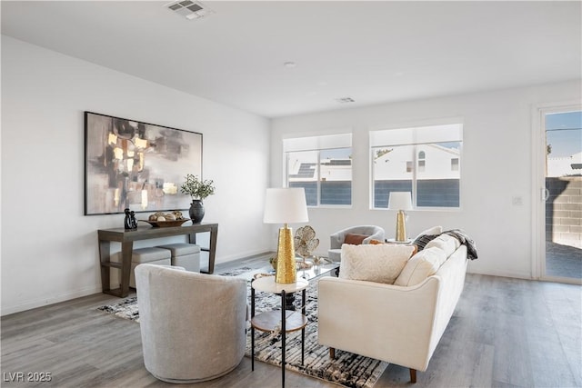 living room with plenty of natural light and wood-type flooring