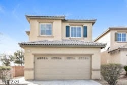 mediterranean / spanish-style house with a garage