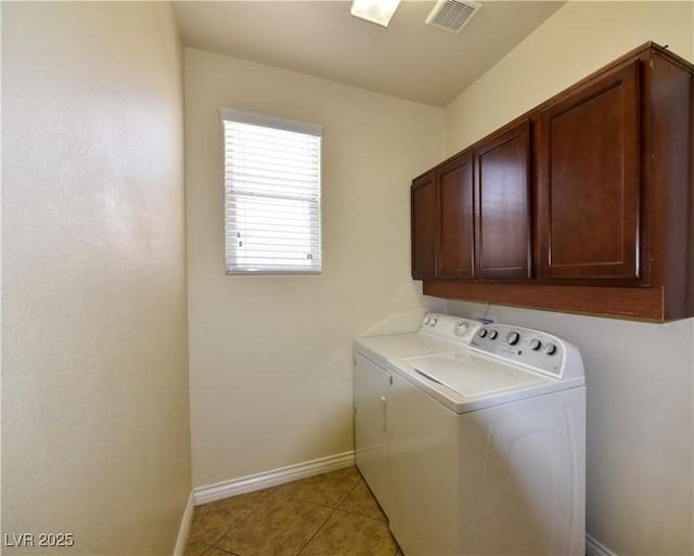 clothes washing area with cabinets, independent washer and dryer, and light tile patterned floors