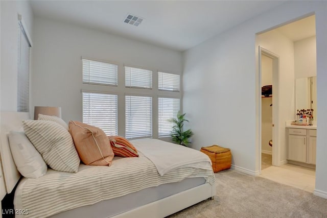 carpeted bedroom with ensuite bathroom