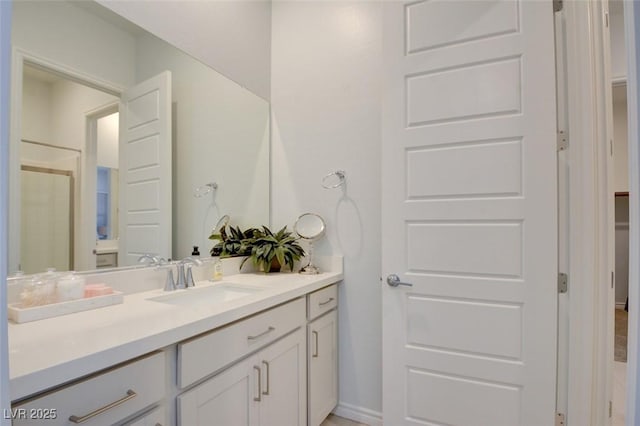 bathroom featuring vanity and a shower with shower door