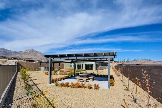 back of house featuring a pergola, a mountain view, and a patio area