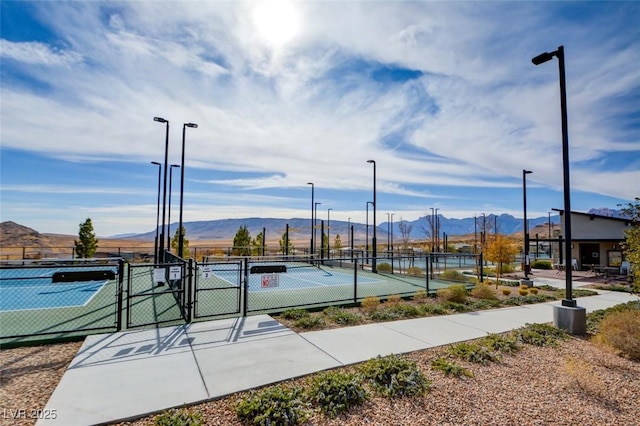 view of basketball court featuring a mountain view and tennis court