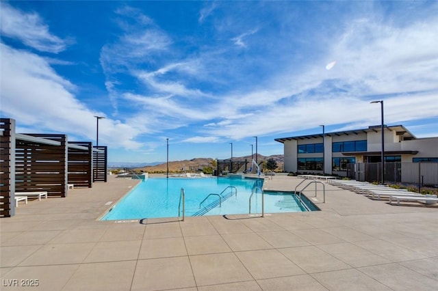 view of swimming pool featuring a water slide and a patio area