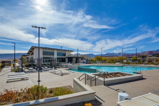 view of pool featuring a mountain view and a patio