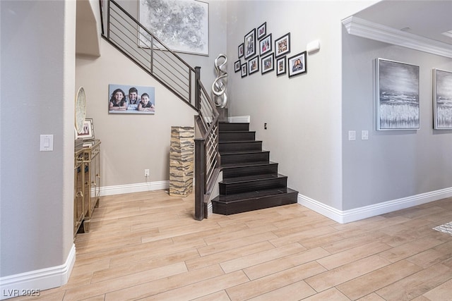 stairway featuring hardwood / wood-style flooring and ornamental molding