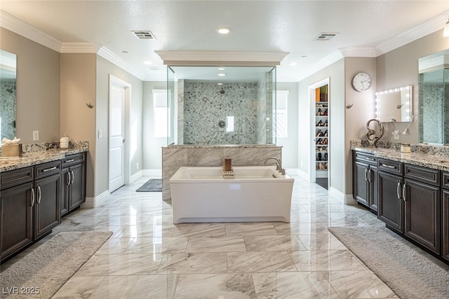 bathroom with vanity, ornamental molding, and independent shower and bath