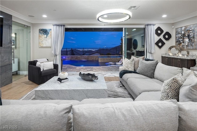 living room with ornamental molding and light wood-type flooring