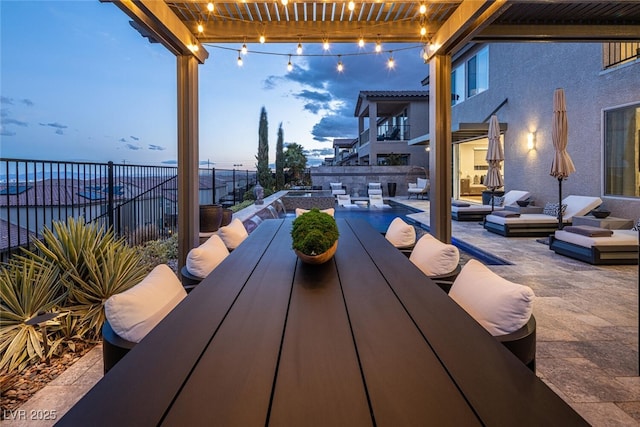 patio terrace at dusk with an outdoor hangout area and a pergola