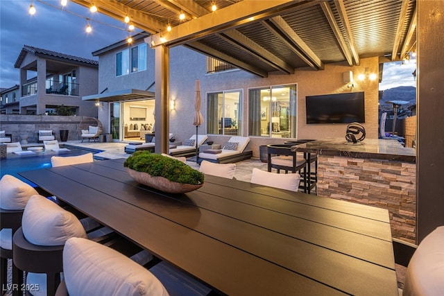 view of patio with a bar, a fenced in pool, and outdoor lounge area