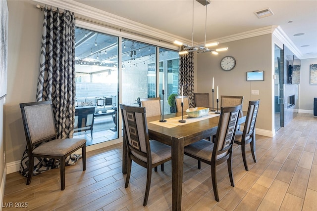 dining room with a notable chandelier and crown molding