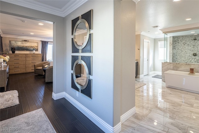 hallway with hardwood / wood-style flooring and ornamental molding