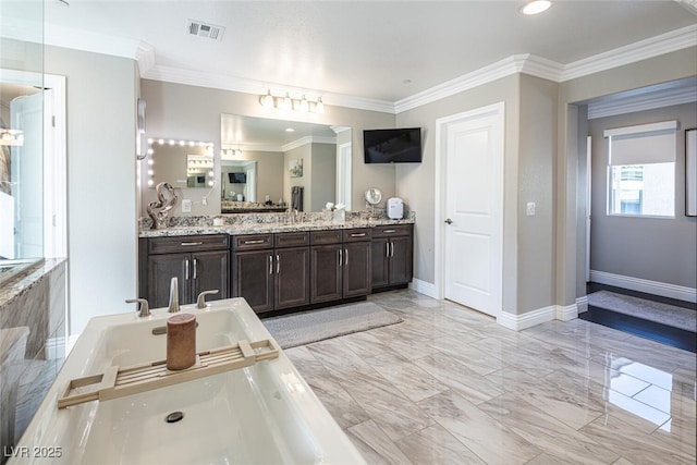 bathroom with vanity, ornamental molding, and a tub to relax in