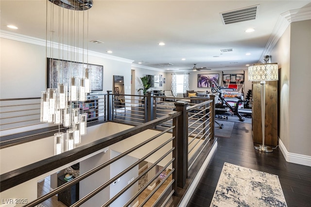 gym featuring crown molding and dark hardwood / wood-style floors