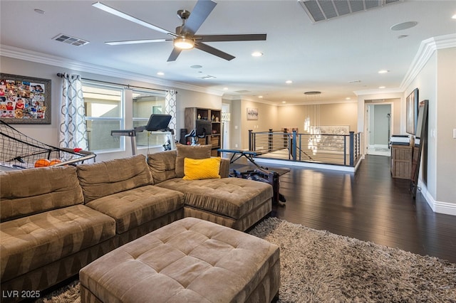 living room featuring crown molding, dark wood-type flooring, and ceiling fan