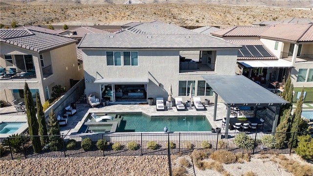 back of property featuring a fenced in pool and a patio area