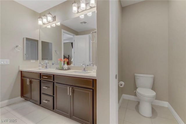 bathroom featuring vanity, tile patterned floors, and toilet