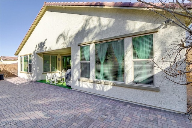 view of side of property with a patio area