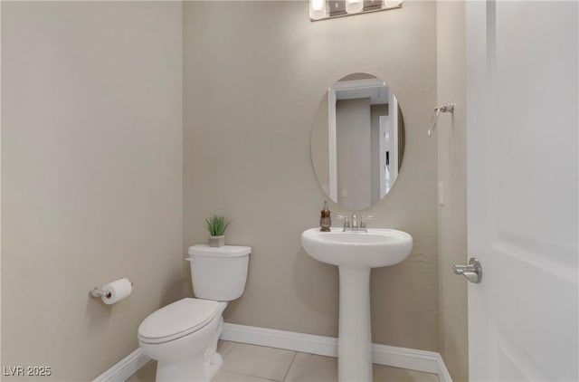 bathroom with sink, tile patterned floors, and toilet