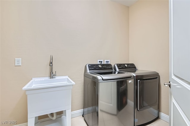 washroom featuring sink and washer and clothes dryer