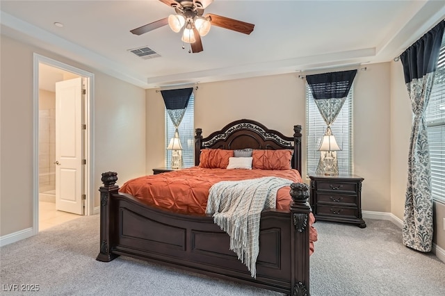 bedroom featuring connected bathroom, light colored carpet, and ceiling fan