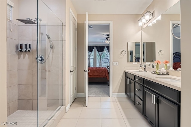 bathroom featuring ceiling fan, tile patterned floors, vanity, and a tile shower