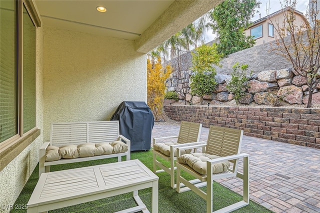 view of patio with grilling area and an outdoor hangout area