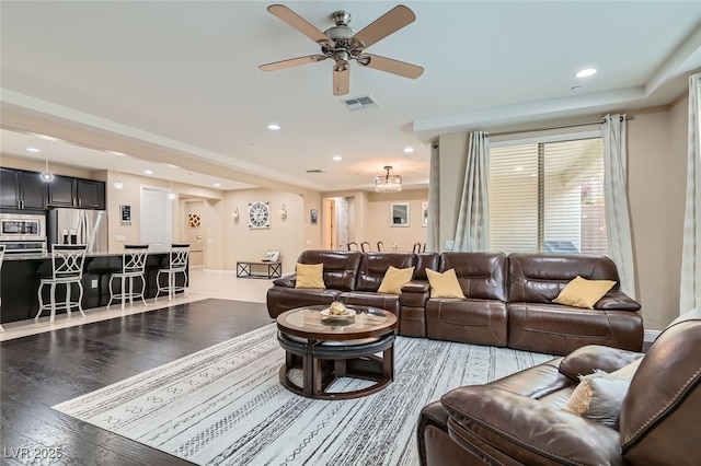 living room featuring hardwood / wood-style flooring and ceiling fan