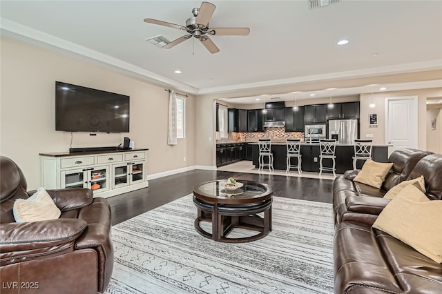 living room with ceiling fan and dark hardwood / wood-style floors