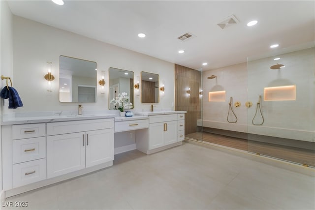 bathroom featuring vanity and tiled shower