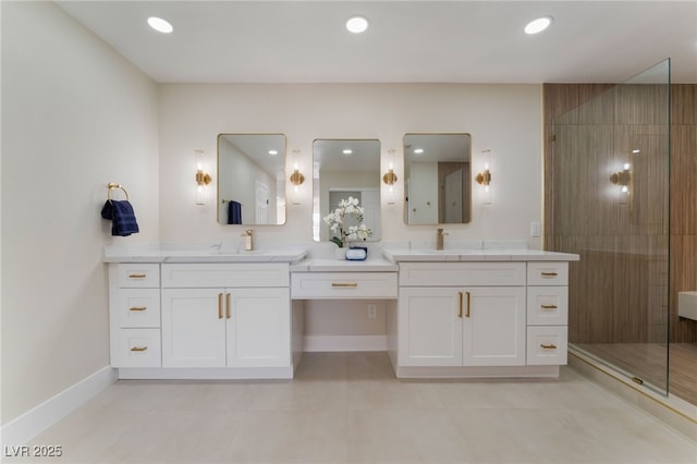 bathroom with vanity, a tile shower, and tile patterned floors