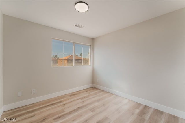 spare room with light hardwood / wood-style flooring