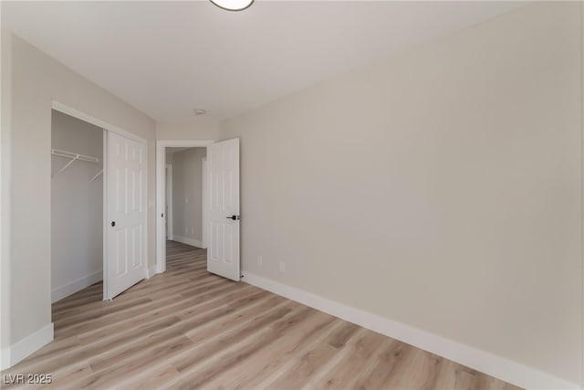 unfurnished bedroom featuring a closet and light hardwood / wood-style flooring