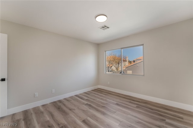 spare room featuring light hardwood / wood-style floors