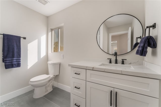 bathroom with tile patterned flooring, vanity, and toilet