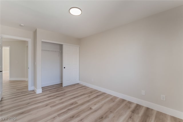 unfurnished bedroom featuring a closet and light hardwood / wood-style flooring